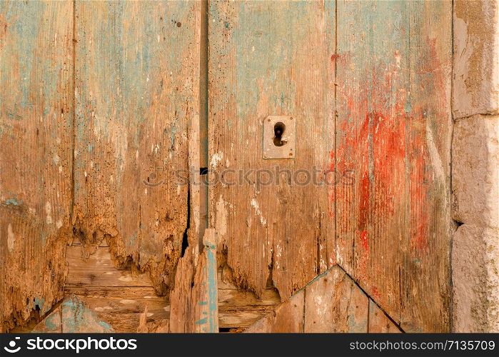 Close-up of very old grungy brown wooden weathered doors in Siranades on Corfu, Greece.