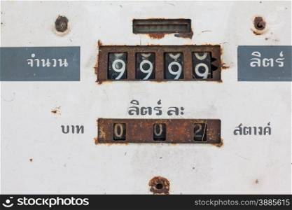 Close up of vintage dial fuel dispenser with thai