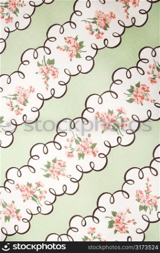 Close-up of vintage fabric with pink flowers in wide stripes printed on polyester.