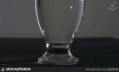 Close up of vitamin powder dissolution in a glass of water