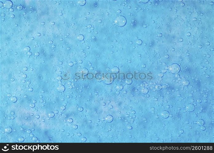 Close-up of water drops on a blue surface