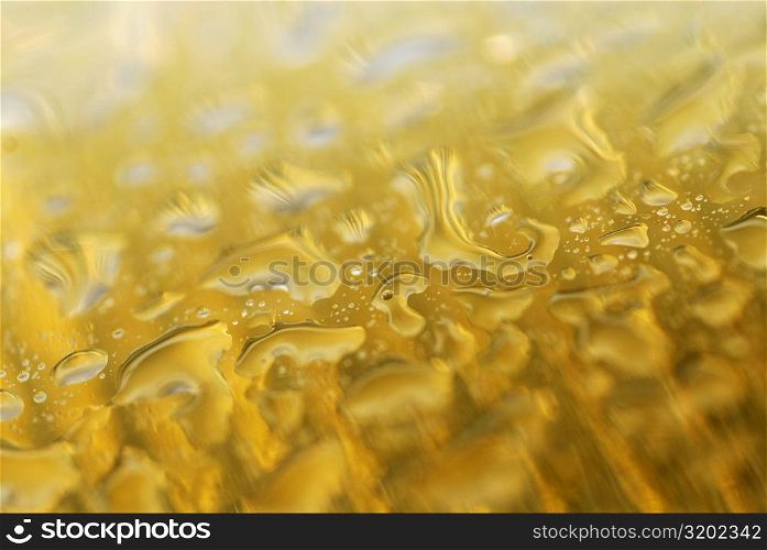 Close-up of water drops on a yellow surface