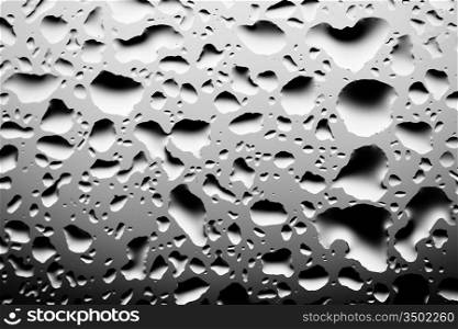 close up of water drops on glass surface, black and white toned