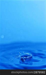 Close-up of water splash on blue background. Water abstract