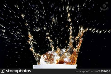 Close-up of water splashing out of a glass