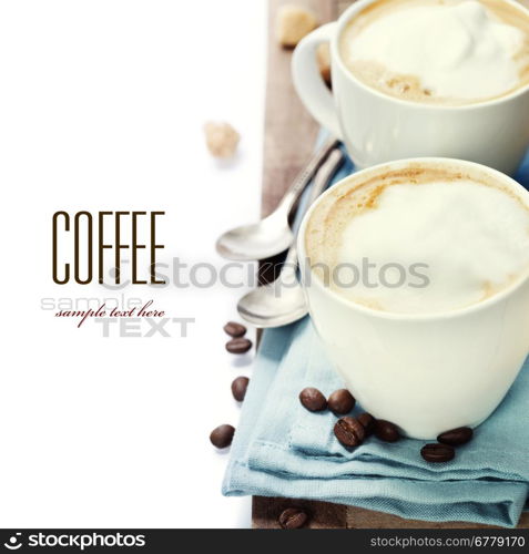 Close-up of white cup of coffee with blue napkin (with sample text)