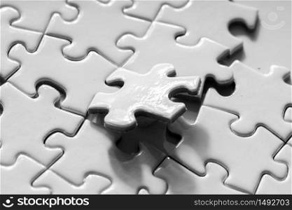 Close up of white jigsaw for business concept