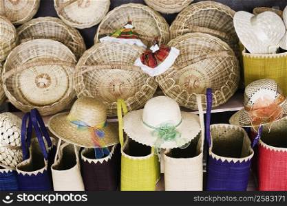 Close-up of wicker baskets and hand bags with straw hats