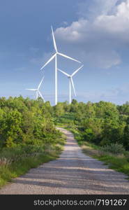 Close up of wind turbines in blue sky