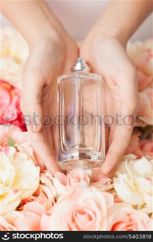 close up of woman&#39;s hands showing perfume