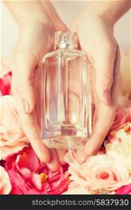 close up of woman&#39;s hands showing perfume