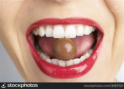 Close-Up Of Woman&acute;s Mouth Biting On Chocolate