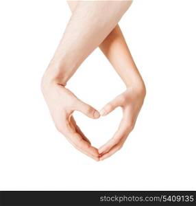 close up of woman and man hands showing heart shape