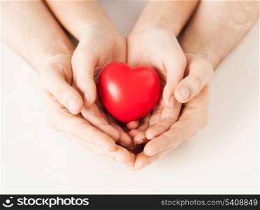 close up of woman and man hands with heart