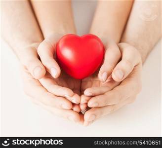 close up of woman and man hands with heart
