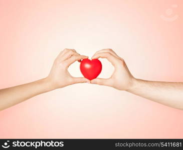 close up of woman and man hands with heart