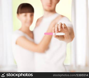 close up of woman and man hands with pregnancy test