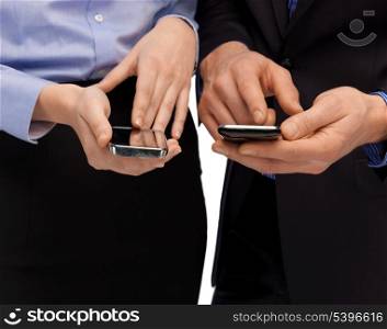 close up of woman and man hands with smartphones