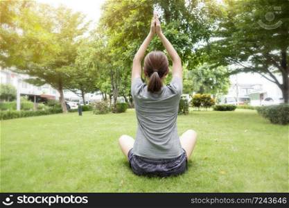 Close up of woman doing Yoga in green garden