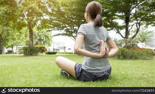 Close up of woman doing Yoga in green garden