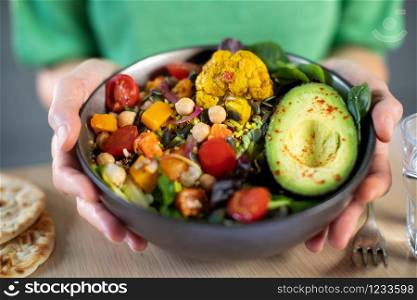 Close Up Of Woman Eating Healthy Vegan Meal In Bowl