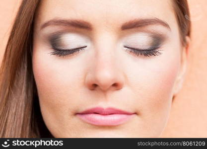 Close up of woman face with make up.. Cosmetics and beauty. Close up portrait of woman with white gray make up. Attractive girl in straight hair.