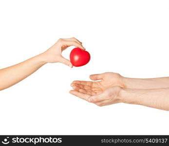 close up of woman hand giving heart to man