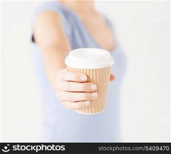 close up of woman hand holding take away coffee cup