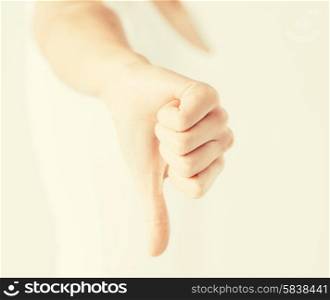 close up of woman hand showing thumbs down