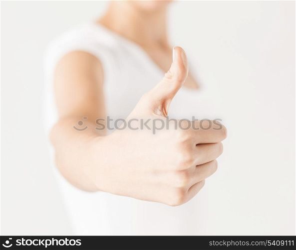 close up of woman hand showing thumbs up