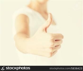 close up of woman hand showing thumbs up