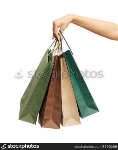 close up of woman hands holding shopping bags