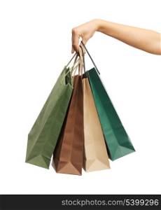close up of woman hands holding shopping bags