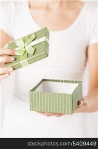 close up of woman hands opening gift box.