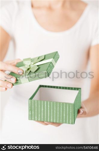 close up of woman hands opening gift box