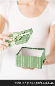close up of woman hands opening gift box