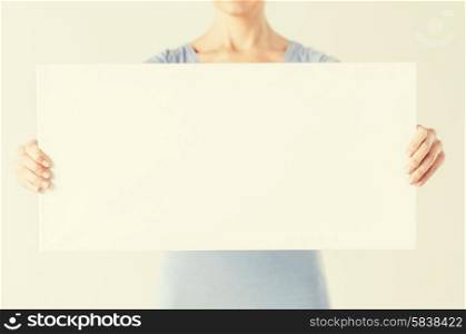 close up of woman hands showing white blank board