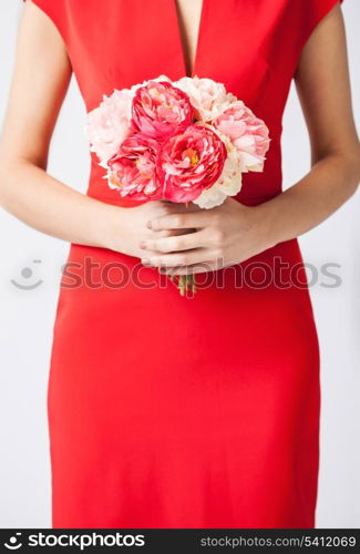 close up of woman hands with bouquet of flowers.