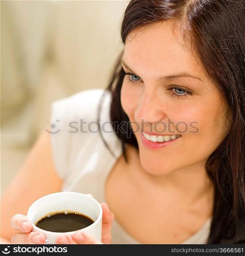 Close up of woman holding a cup of coffee