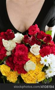 Close up of woman holding bouquet of coloured flowers