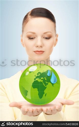 close up of woman holding green globe in her hands