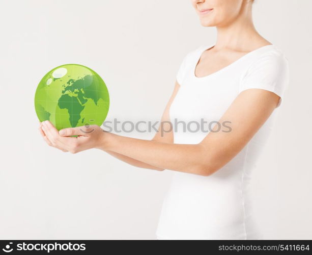 close up of woman holding green sphere globe