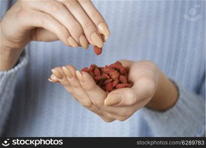 Close Up Of Woman Holding Handful Of Goji Berries
