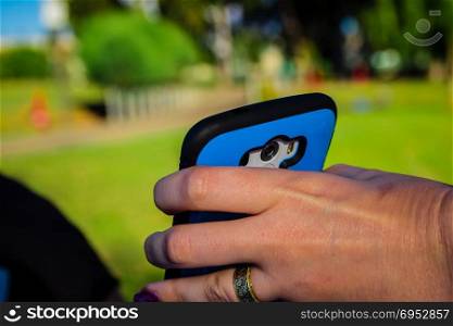 Close up of woman holding smartphone with her hand.