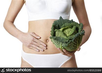 Close Up Of Woman In Underwear Holding Cabbage And Touching Stomach