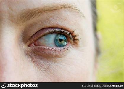 Close-up of woman looking out of the corner of her eye.