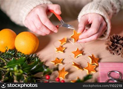 Close Up Of Woman Making Eco Friendly Eco Christmas Decorations From Orange Peel