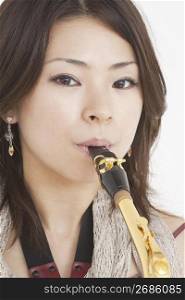 Close up of woman playing saxophone
