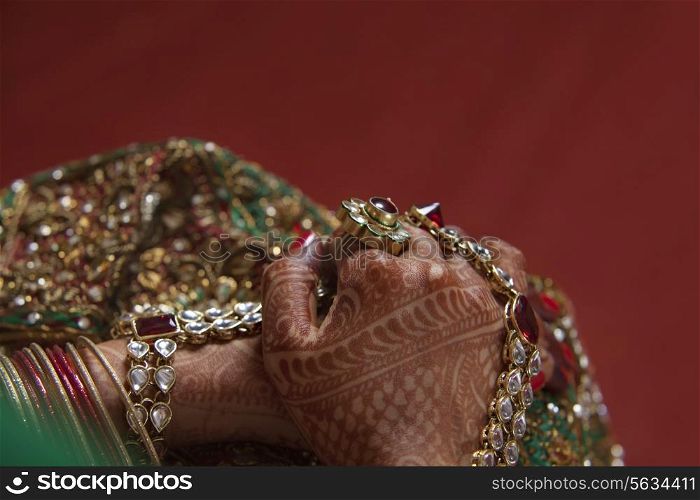 Close-up of woman&rsquo;s hand covered with henna