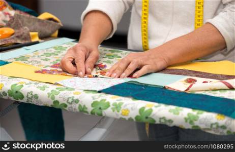 Close up of woman&rsquo;s hand sewing patchwork